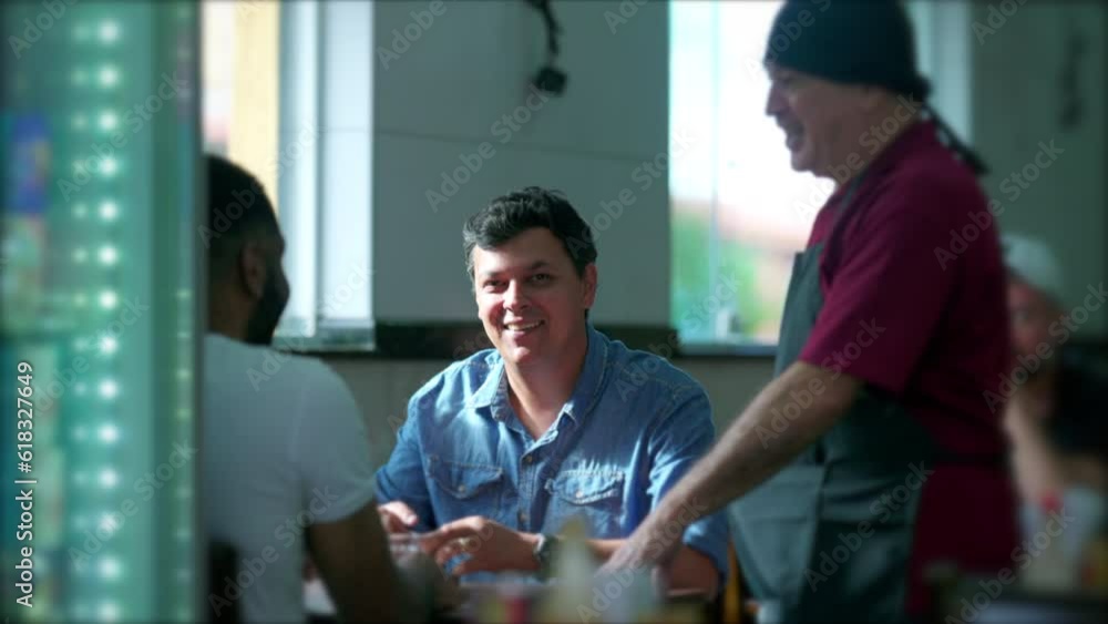 Candid Interaction between Customer and Waiter at Restaurant. Casual conversation of client with server at traditional cafeteria in South America Candid Interaction between Customer and Waiter at Restaurant. Casual conversation of client with server at traditional cafeteria in South America