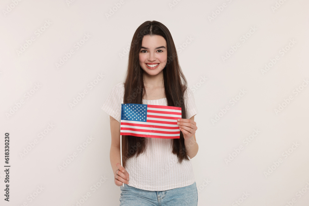 4th of July - Independence Day of USA. Happy girl with American flag on white background 4th of July - Independence Day of USA. Happy girl with American flag on white background