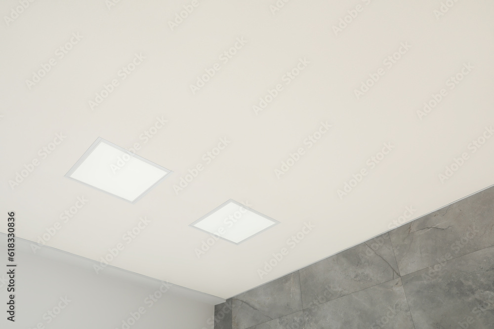 White ceiling with modern lighting in room, low angle view White ceiling with modern lighting in room, low angle view
