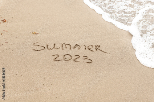 Summer 2023 written on the sand