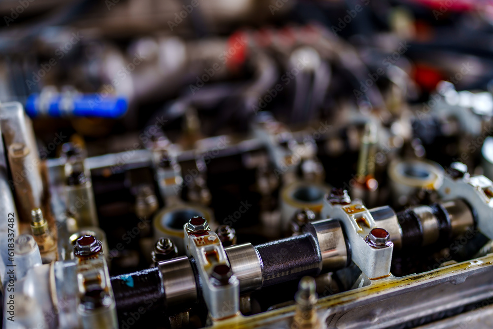 Auto mechanic repair engine in a car repair shop and Checking a car engine for repair at car garage.Car engine repair. Car service Auto mechanic repair engine in a car repair shop and Checking a car engine for repair at car garage.Car engine repair. Car service