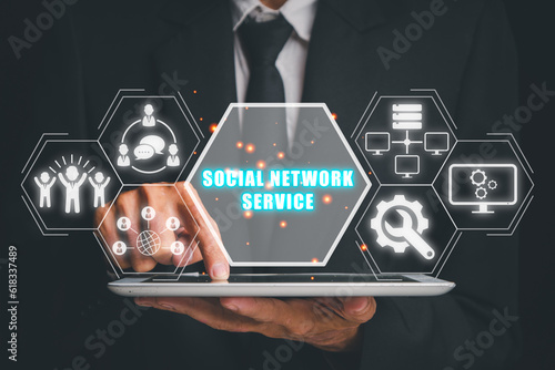 Social network service concept, Business person using tablet computer with social network service icon on virtual screen.