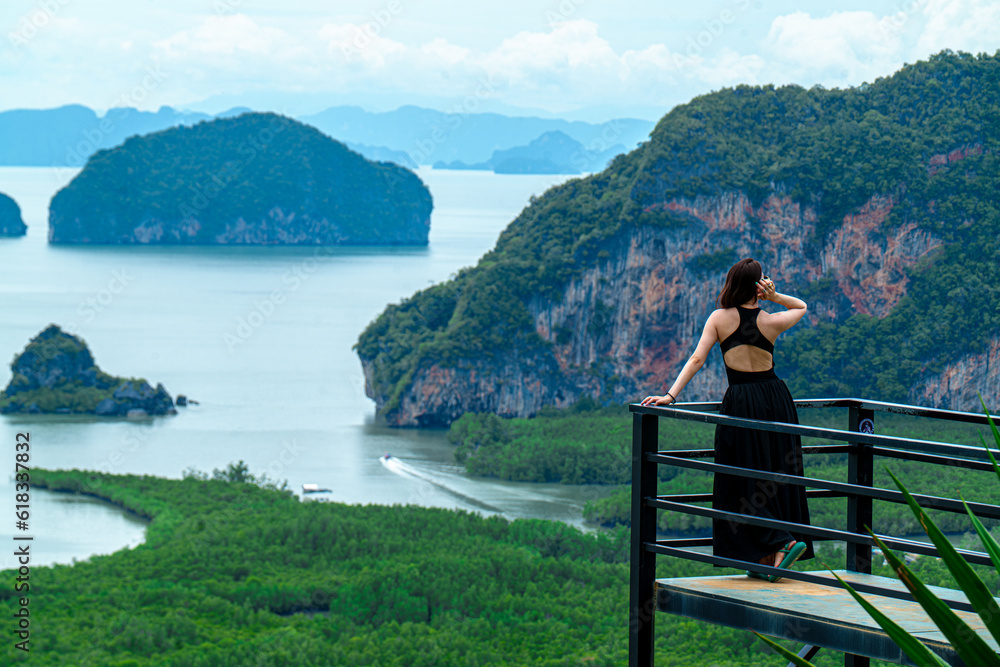 Fototapeta premium Happy traveler man enjoy Phang Nga bay view point,View of Phang Nga bay from Samet Nangshe viewpoint at rainstorm