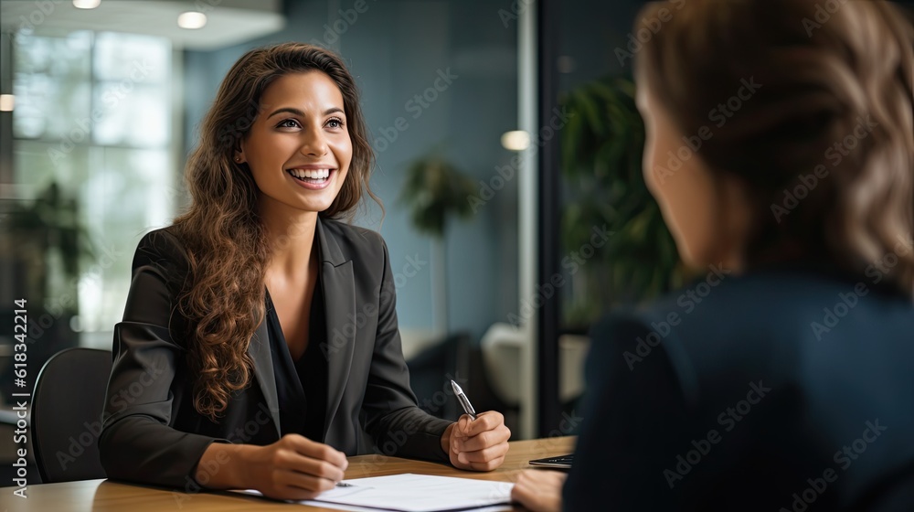 Smiling Female Manager Interviewing an Applicant In Office - obrazy, fototapety, plakaty 