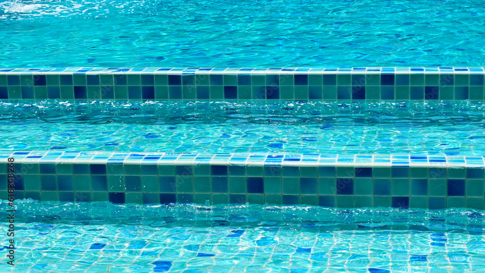surface of blue swimming pool with stair, freshness water background
