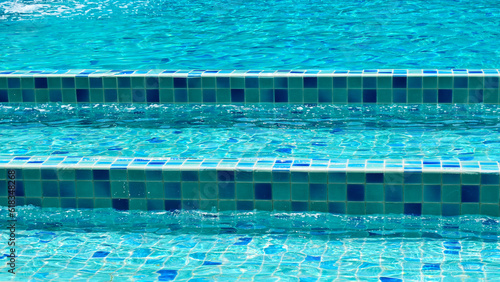 surface of blue swimming pool with stair, freshness water background