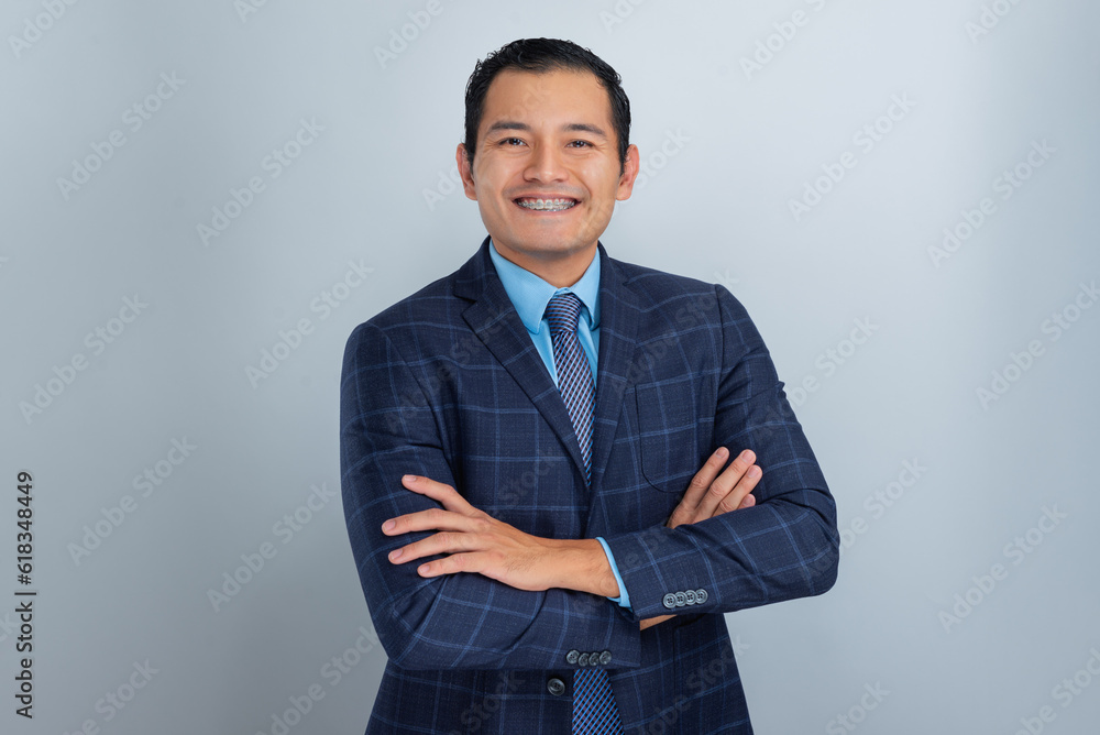 successful young hispanic dark skinned man smiles with arms crossed in his blue jacket and tie, office boy successful young hispanic dark skinned man smiles with arms crossed in his blue jacket and tie, office boy