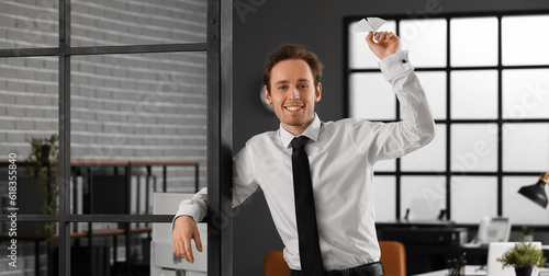 Happy young businessman thr...