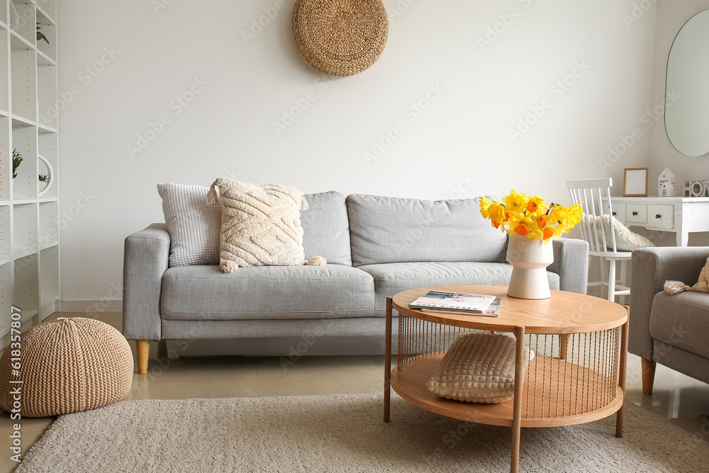 Interior of modern living room with cozy sofa and flower vase on coffee ...