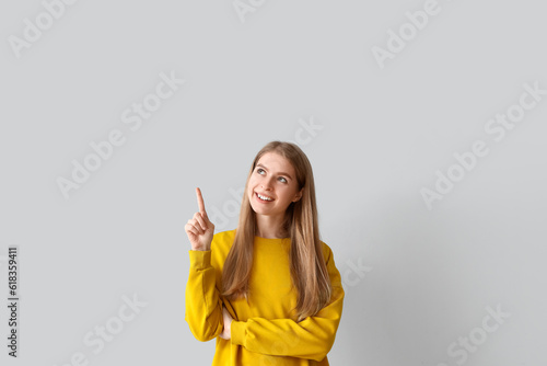 Thoughtful young woman poin...