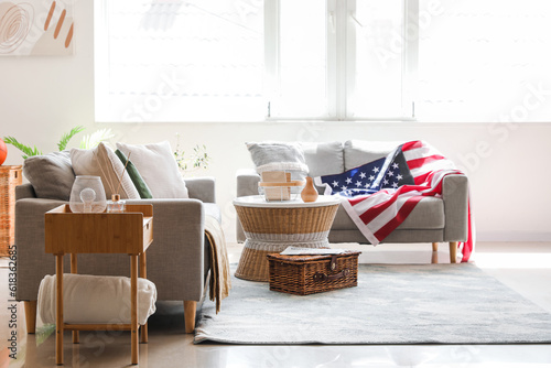 Interior of stylish living room with USA flag on sofa © Pixel-Shot