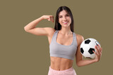 Sporty young woman with soccer ball on color background