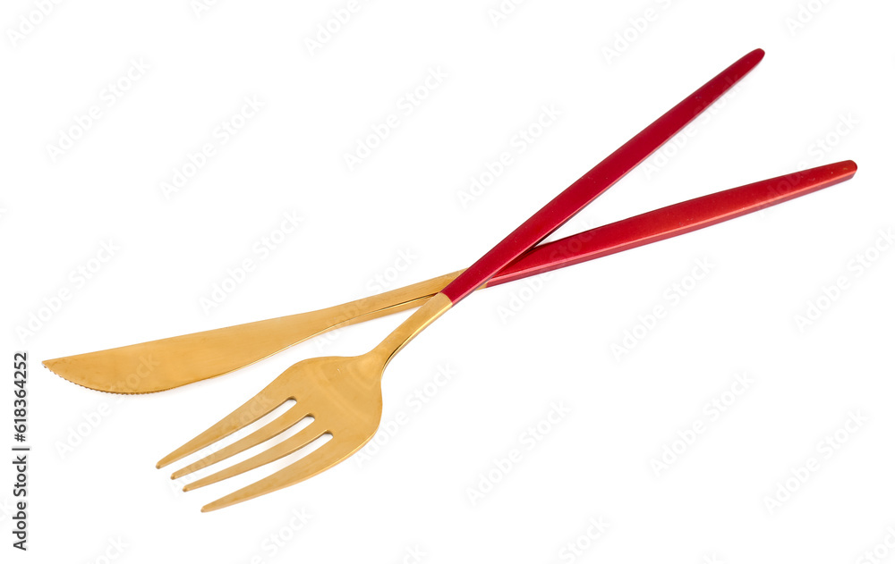 Golden fork and knife with red handles on white background Golden fork and knife with red handles on white background