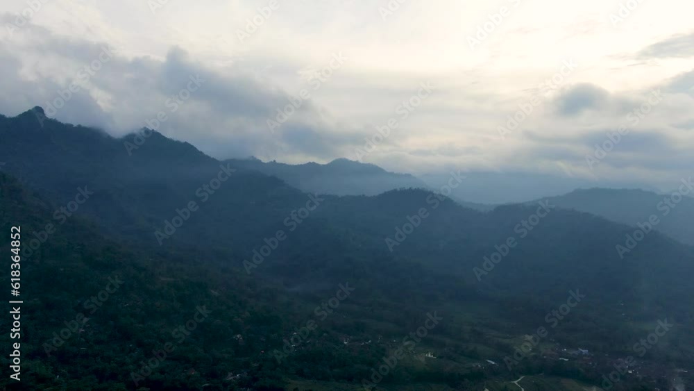 Silhouette of Menoreh mountains on foggy afternoon, aerial drone view Silhouette of Menoreh mountains on foggy afternoon, aerial drone view