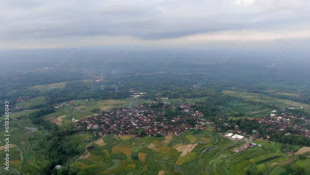 Small township in vast Indonesia landscape, aerial drone view Small township in vast Indonesia landscape, aerial drone view