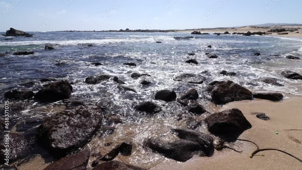 waves over the rocks at Tunquen beach during the day waves over the rocks at Tunquen beach during the day