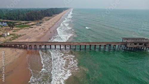 abandoned walking bridge and beautiful beach waves areal drone shot addaripeta beach 4k photo