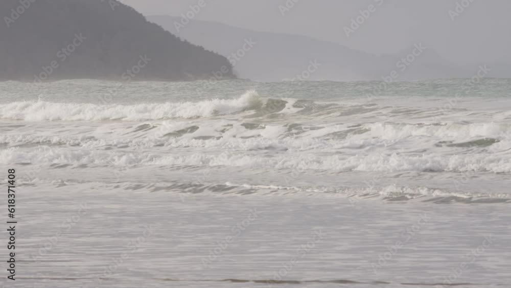 Pan shot over perfect Castle Point waves at the beach in New Zealand Pan shot over perfect Castle Point waves at the beach in New Zealand