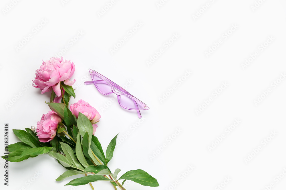 Obraz premium Stylish female sunglasses and beautiful peony flowers on white background