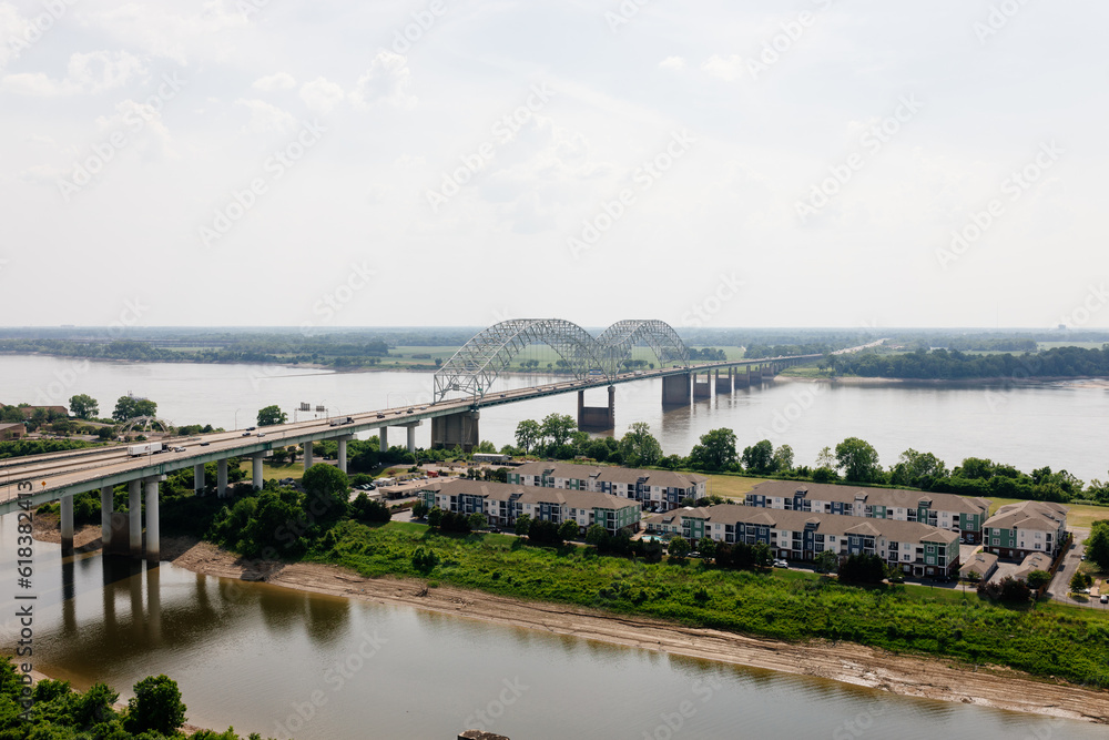 Big beautiful bridge across the river on a cloudy summer day. Bridge in Memphis, Tennessee aerial view on spring day Big beautiful bridge across the river on a cloudy summer day. Bridge in Memphis, Tennessee aerial view on spring day