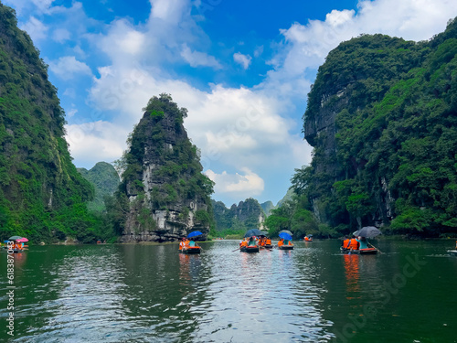 Trang An River Ninh Minh and Bai Dinh Mountain ranges in Vietnam only 3 hours drive from Hanoi. Beautiful winding river and large rising mountains. boats going through the caves in the river