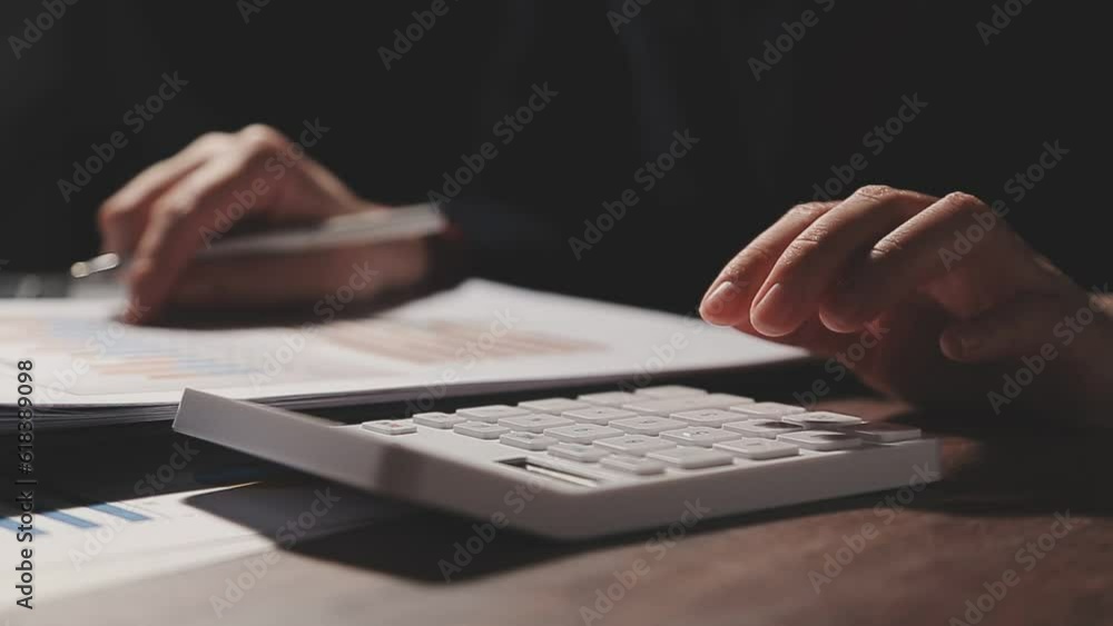 Close up businessman hand using calculator and working with laptop calculate about finance accounting at coffeeshop outdor.finance accounting concept Close up businessman hand using calculator and working with laptop calculate about finance accounting at coffeeshop outdor.finance accounting concept