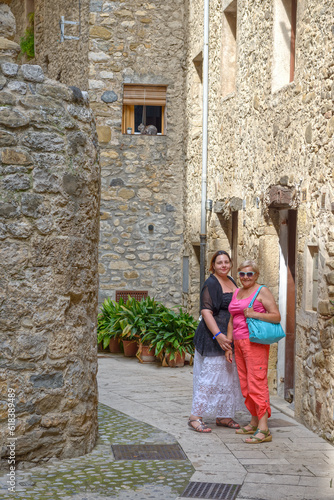 Tourist women are on narrow old street of Besalu, Catalonia. © vaz1
