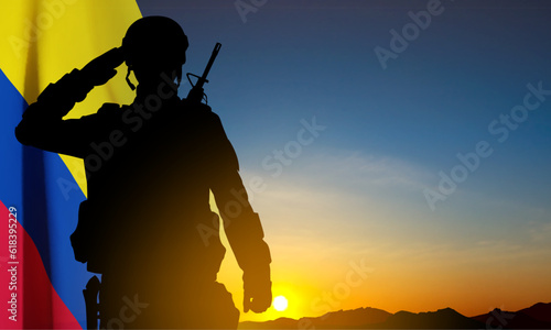 Silhouette of a soldier with Colombia flag against the sunset. EPS10 vector