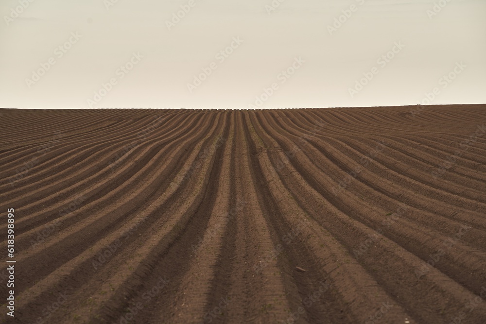 Land on the field for planting. Beautiful plowed field and cloudy sky scene Land on the field for planting. Beautiful plowed field and cloudy sky scene
