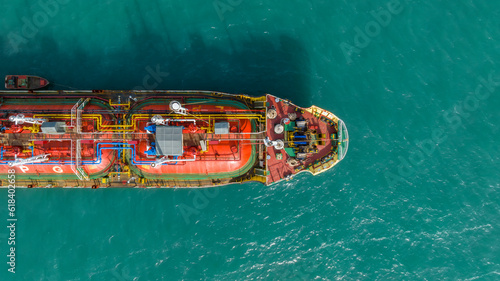 Aerial top view ship tanker gas LPG on the sea for transportation, Sea transportation of Liquefied Petroleum Gas LPG tanker to LPG terminal for gas loading. © Darunrat