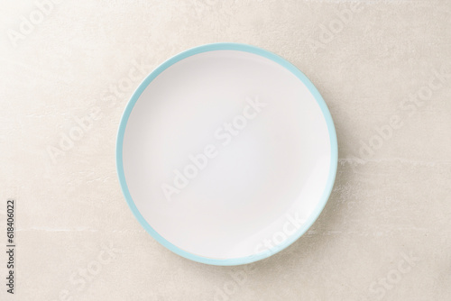 Canvas Print White empty dish on light concrete background, top view