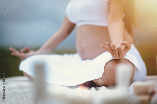 Prenatal care and pregnancy concepts of motherhood. Pregnant woman yoga relaxing and breathing the air and enjoying the baby by the river in the morning.