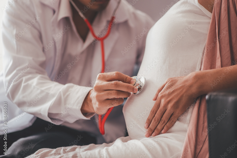 Fototapeta premium Concept Motherhood and Pregnant, Prenatal care and pregnancy, The doctor examined the symptoms of pregnant women and her child for care and safety checks in the womb.