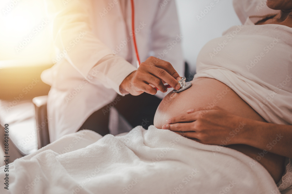 Concept Motherhood and Pregnant, Prenatal care and pregnancy, The doctor examined the symptoms of pregnant women and her child for care and safety checks in the womb.