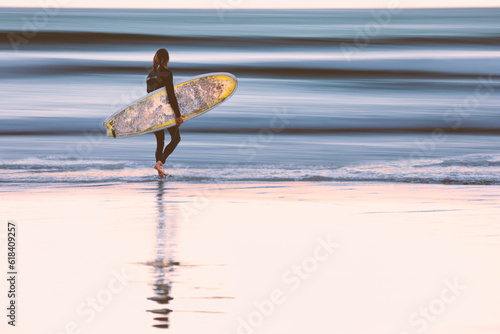 Surfer walking out to the ocean