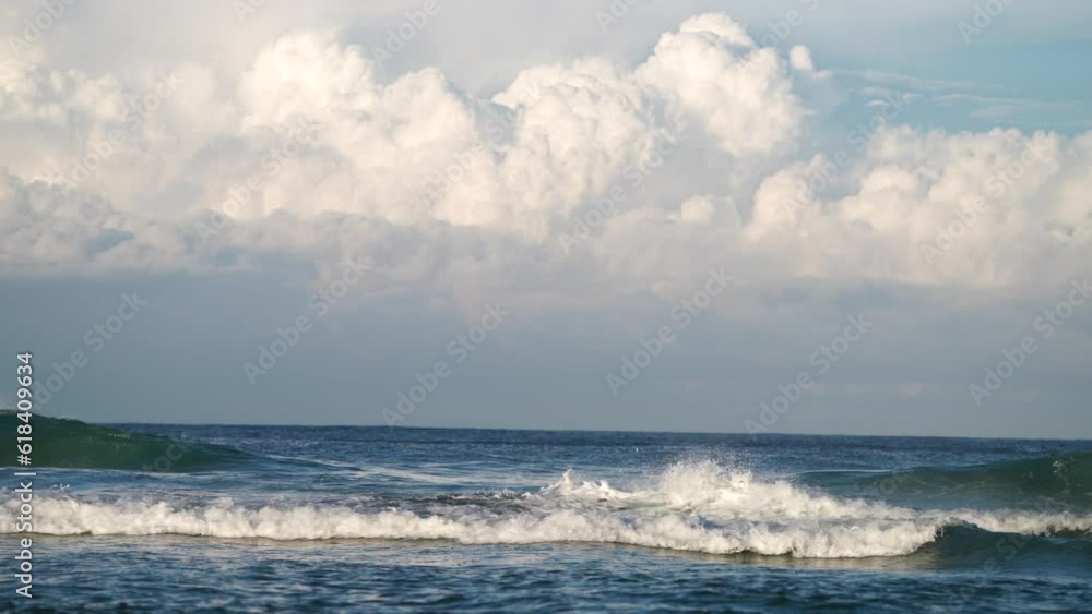 waves breaking in the sand of a beach in australia waves breaking in the sand of a beach in australia