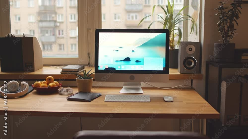 No people zoom in shot of computer with aesthetic nature desktop wallpaper on wooden table by window in warm cozy apartment No people zoom in shot of computer with aesthetic nature desktop wallpaper on wooden table by window in warm cozy apartment