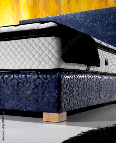 Detail shot of a bed in a hotel room taken from the corner