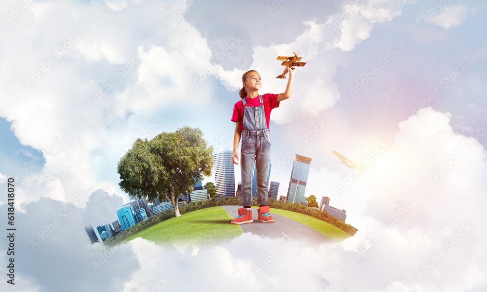 Concept of careless happy childhood with girl dreaming to become pilot
