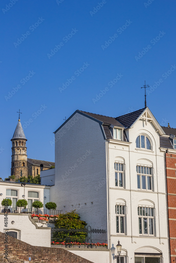 Historic white house and church tower at the city wall in Maastricht, Netherlands