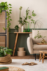 Creative composition of botanic living room interior with beige sofa, carpet, wooden consola, rattan sideboard, plants in flowerpot, vase with leaves and personal accessories. Home decor. Template.
