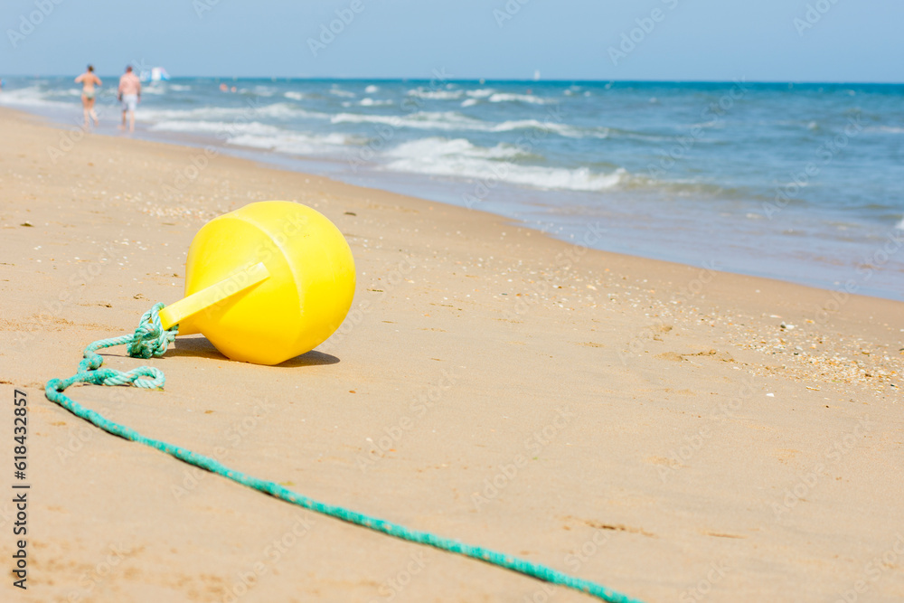 Buoy and rope dividing area on beach. Buoy and rope dividing area on beach.
