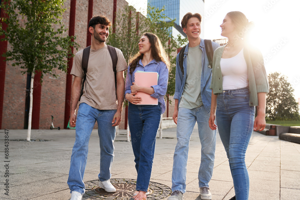 Group of caucasian students walking through university campus