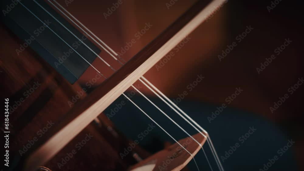 Closeup video of a person playing the big cello on a blurred background Closeup video of a person playing the big cello on a blurred background