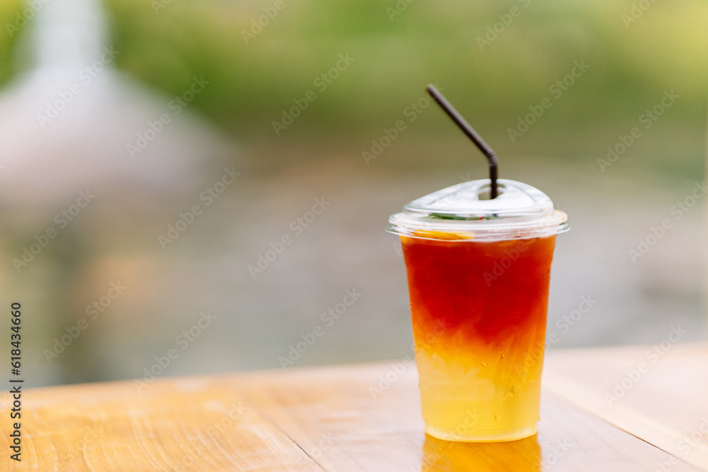 Lemon tea in plastic glasses with straws on the table. Copy space. Lemon tea in plastic glasses with straws on the table. Copy space.