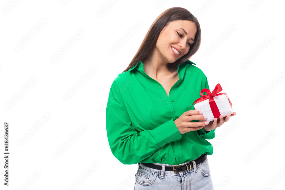 young happy european brunette woman with brown eyes in green blouse holding received a gift from her boyfriend young happy european brunette woman with brown eyes in green blouse holding received a gift from her boyfriend