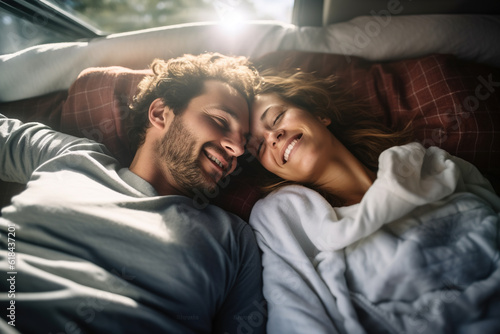 Happy young couple lying together in a van, enjoying vacation time together . Generative AI
