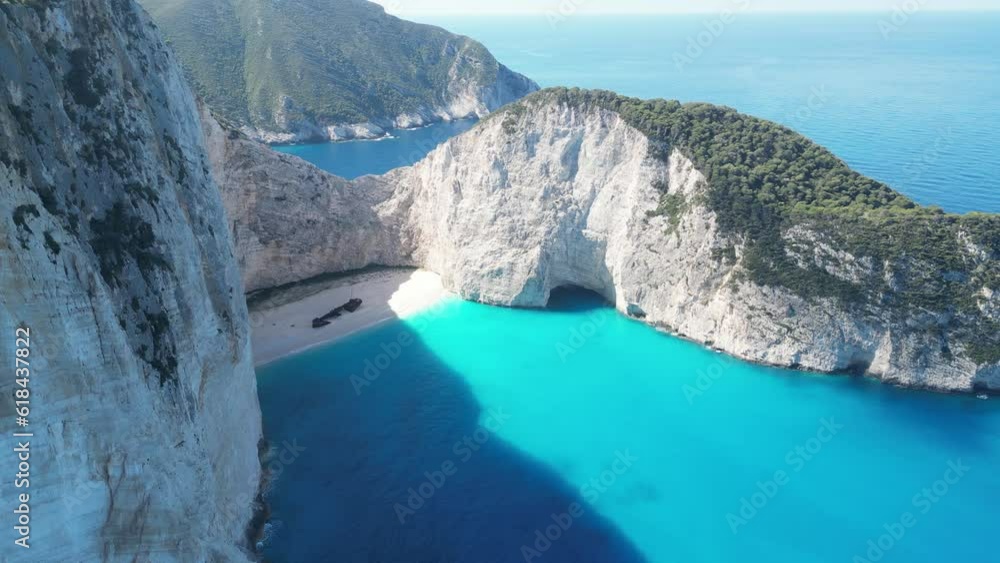 Landscape view of rocky cliffs by turquoise water in Navagio Beach on Zakinthos island, Greece Landscape view of rocky cliffs by turquoise water in Navagio Beach on Zakinthos island, Greece