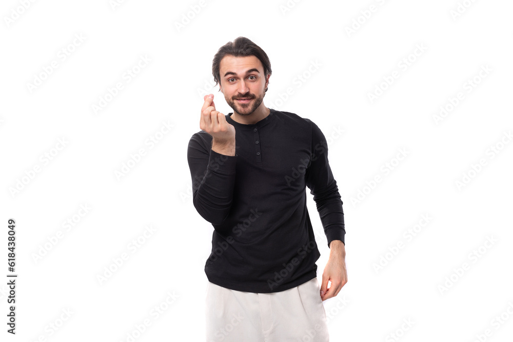 cute brutal macho man with black hair and beard with an earring in his ear on an isolated white background with copy space cute brutal macho man with black hair and beard with an earring in his ear on an isolated white background with copy space