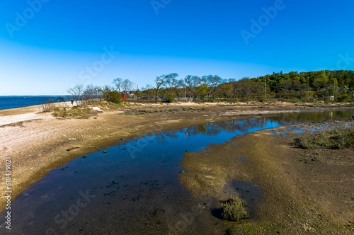 Aerial shot over West Neck Beach on Long Island in the suburb of Lloyd Harbor New York on sunny day